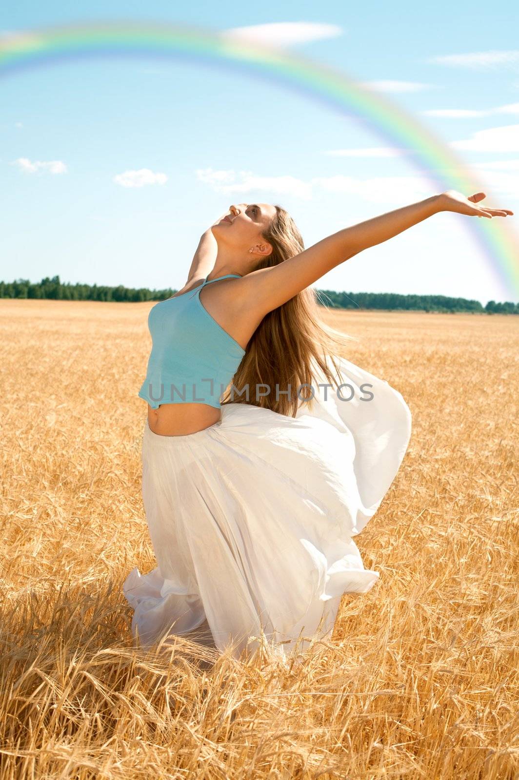fit girl working out at the field under rainbow