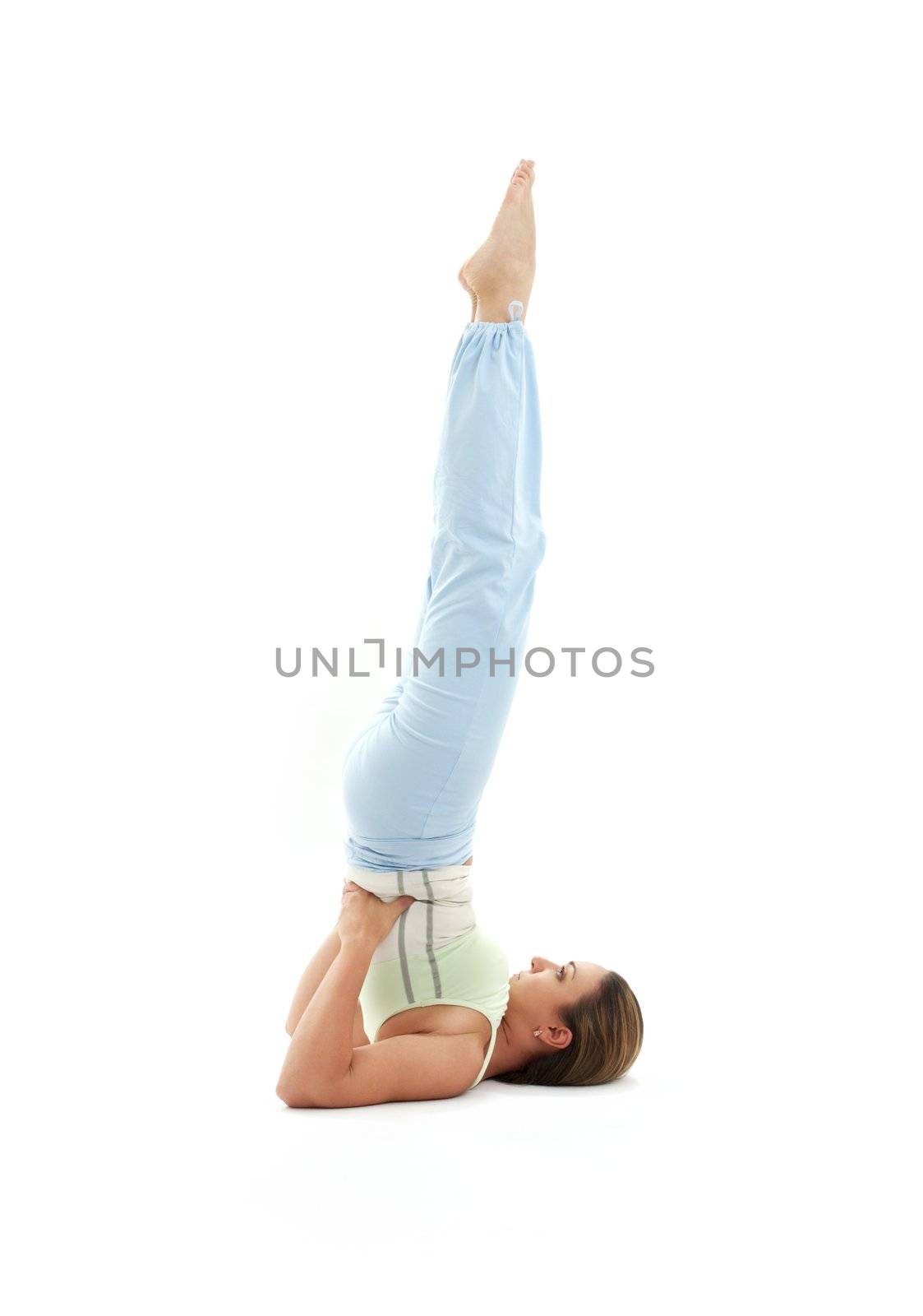 sporty girl practicing salamba sarvangasana supported shoulderstand