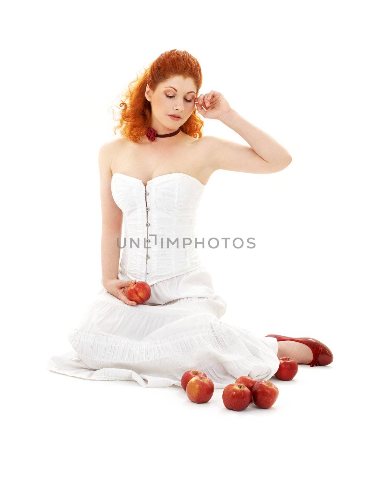 lovely redhead in red shoes with apples over white