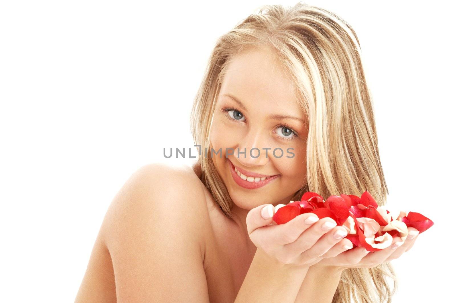 portrait of lovely blond in spa with red and white rose petals