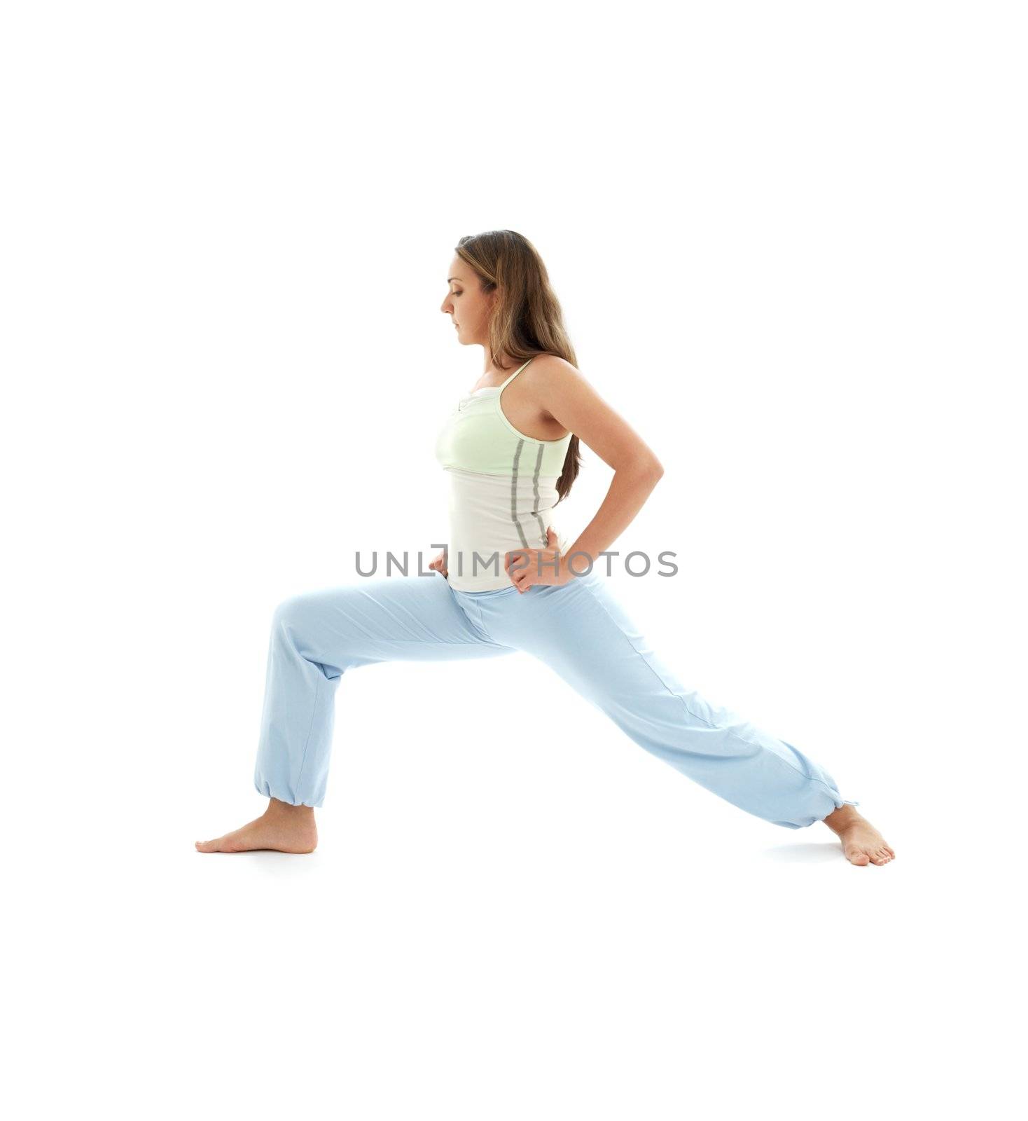 sporty girl practicing virabhadrasana warrior pose over white