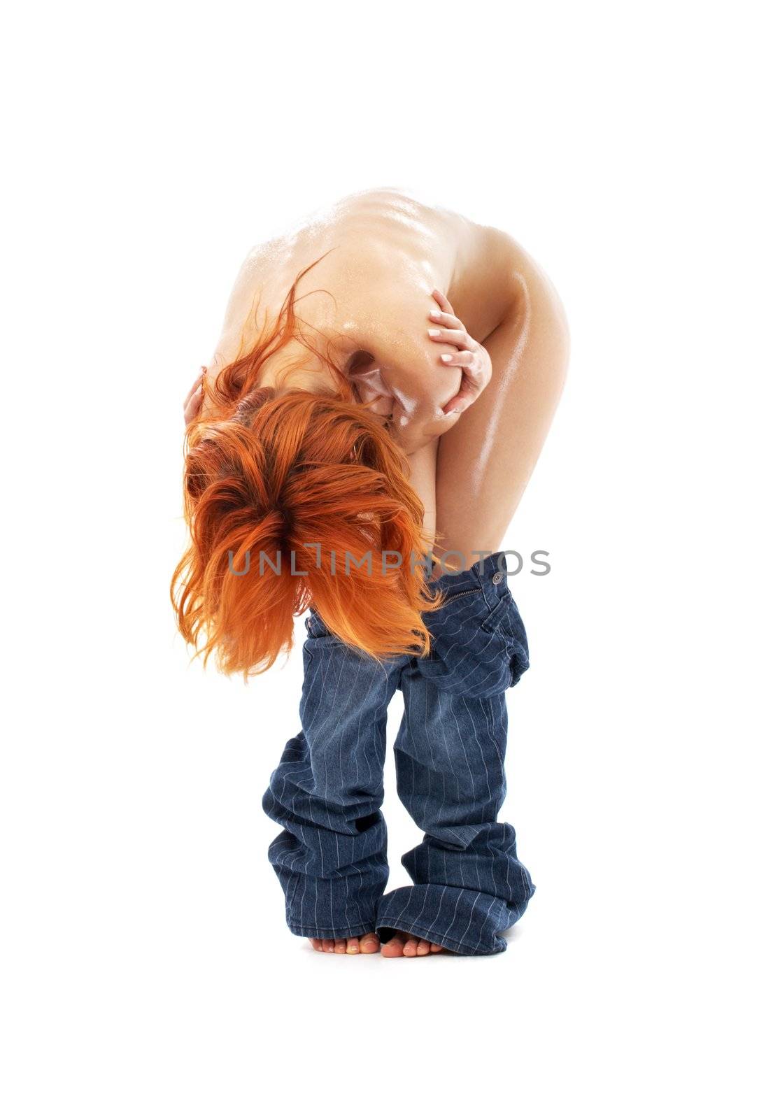 naked redhead in blue jeans over white by dolgachov