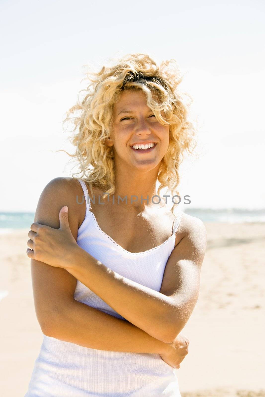 Portrait of pretty young blond woman smiling on Maui, Hawaii beach.