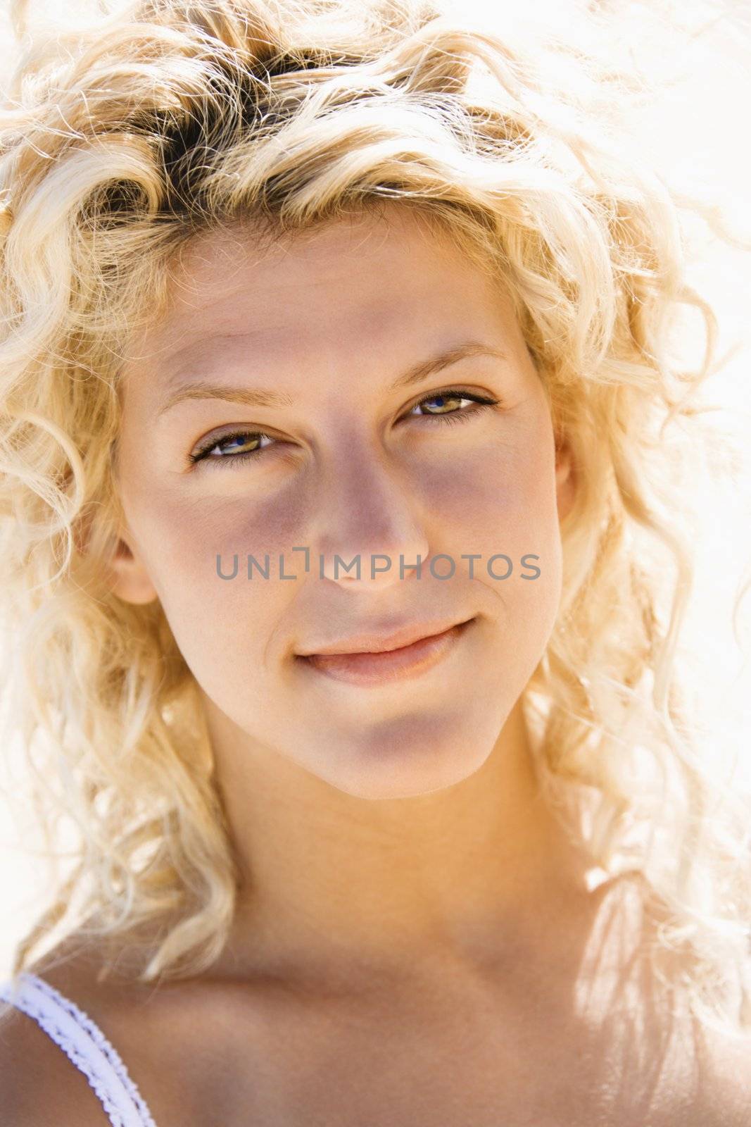 Head and shoulder portrait of pretty young blond woman.