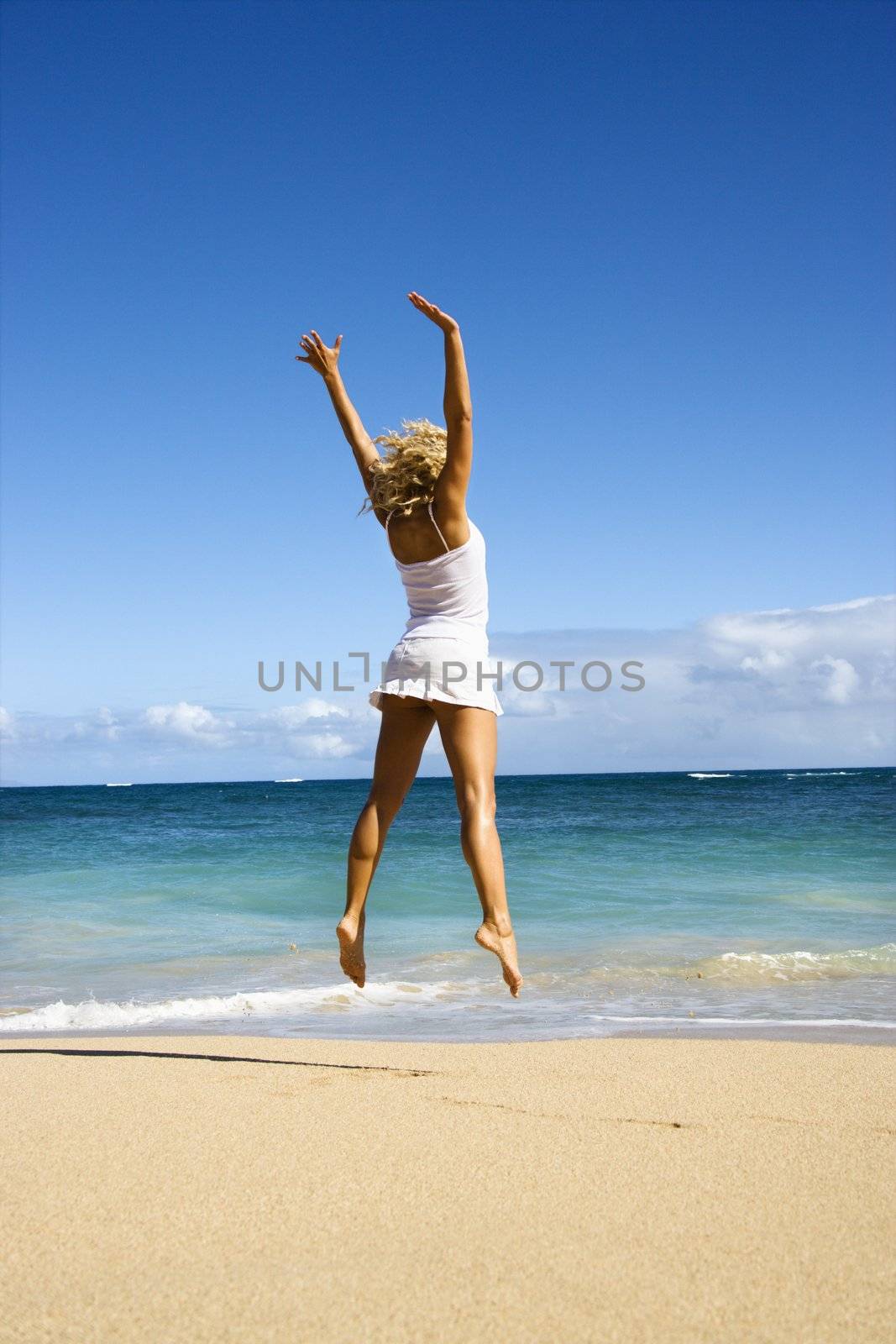 Jumping woman. by iofoto