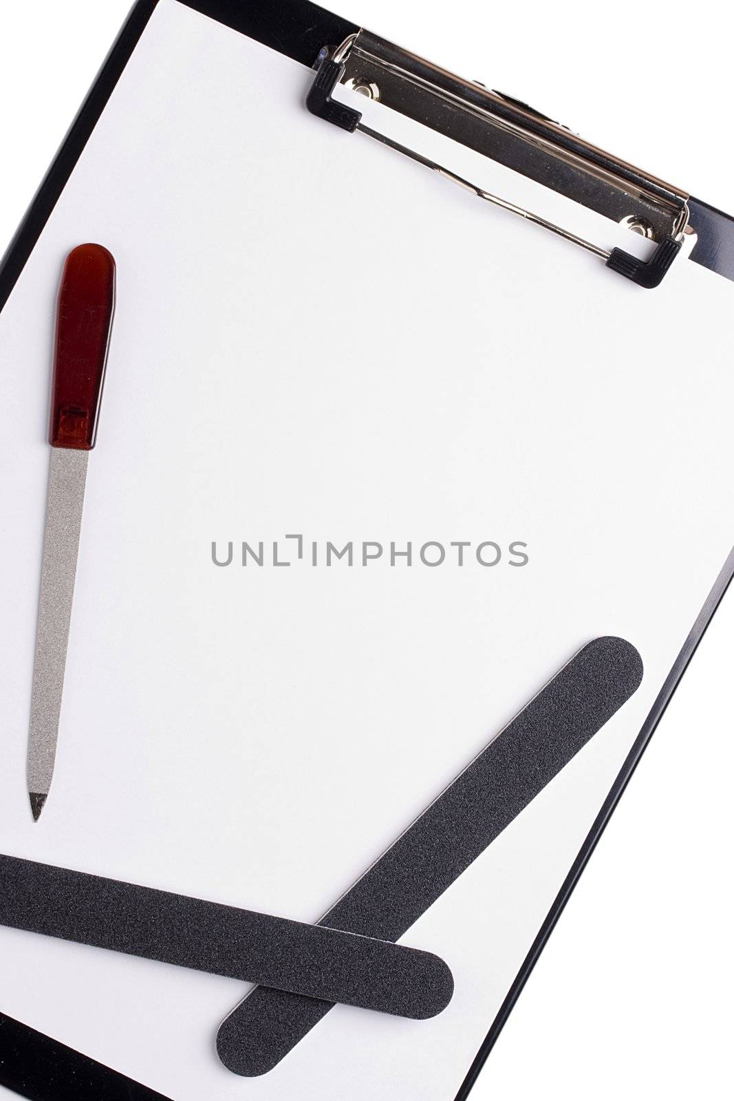 Nail tools laying on a white piece of paper. Add your text to the paper.