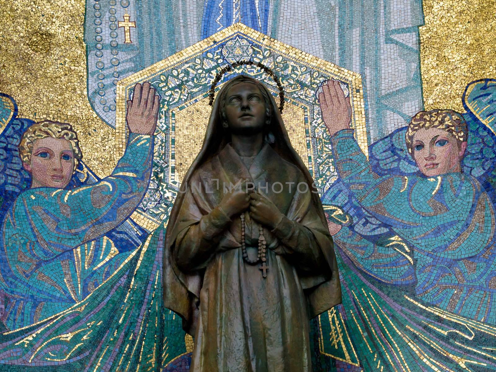 Mosaic of St Bernadette and the Virgin Mary outside the Basilica of the Rosary in Lourdes