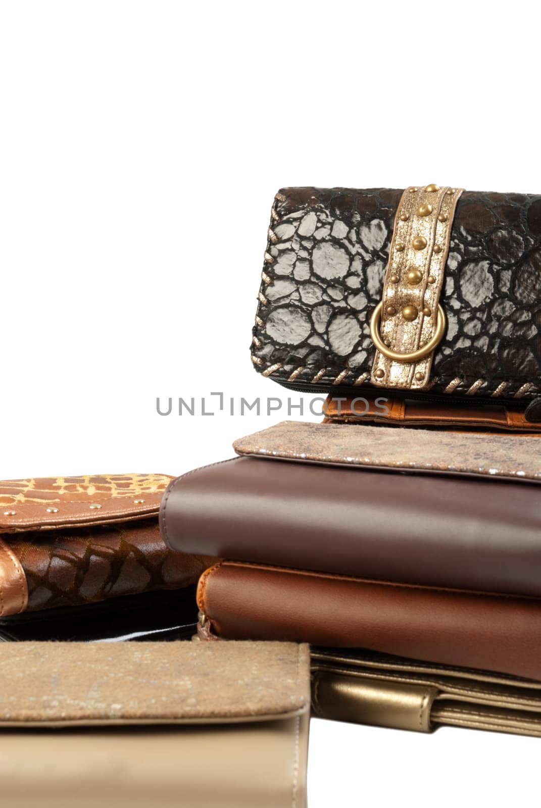 10 leather purses in stack. Isolated on white background