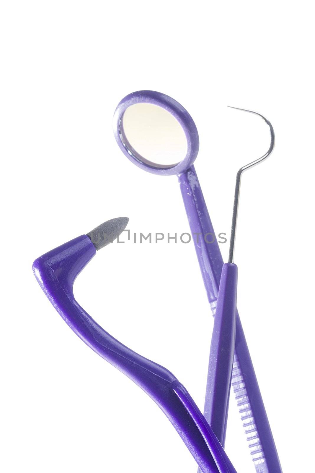 Dental stain eraser, dental mirror, and dental pik on a white background.