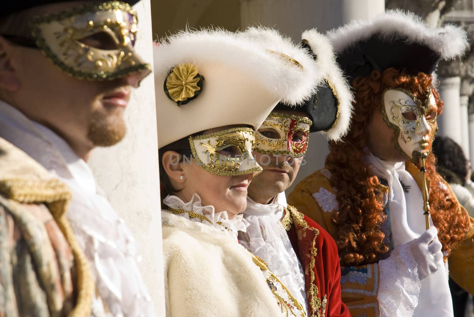 Traditionally dressed Venice carnival performers group in Piazza San Marco, Italy
