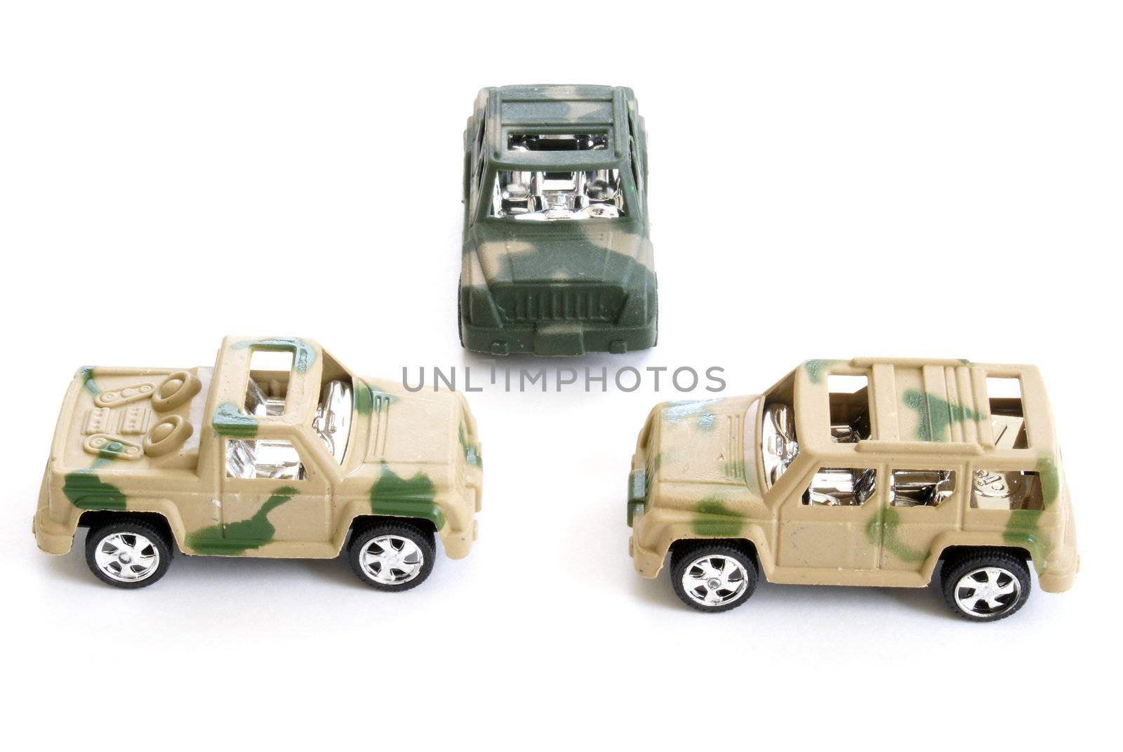 Three toy military vehicles on white background.