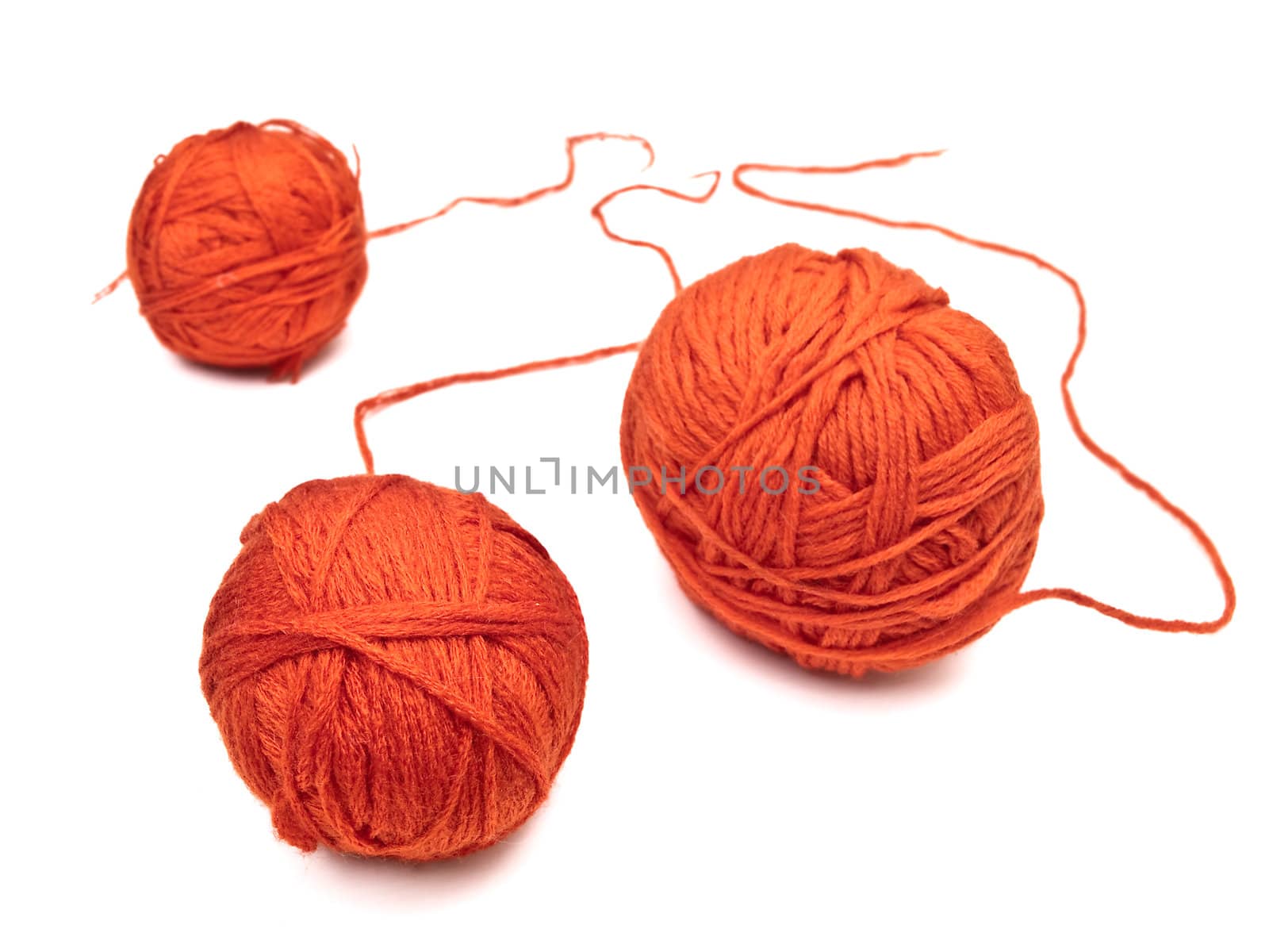 red yarns clews against the white background