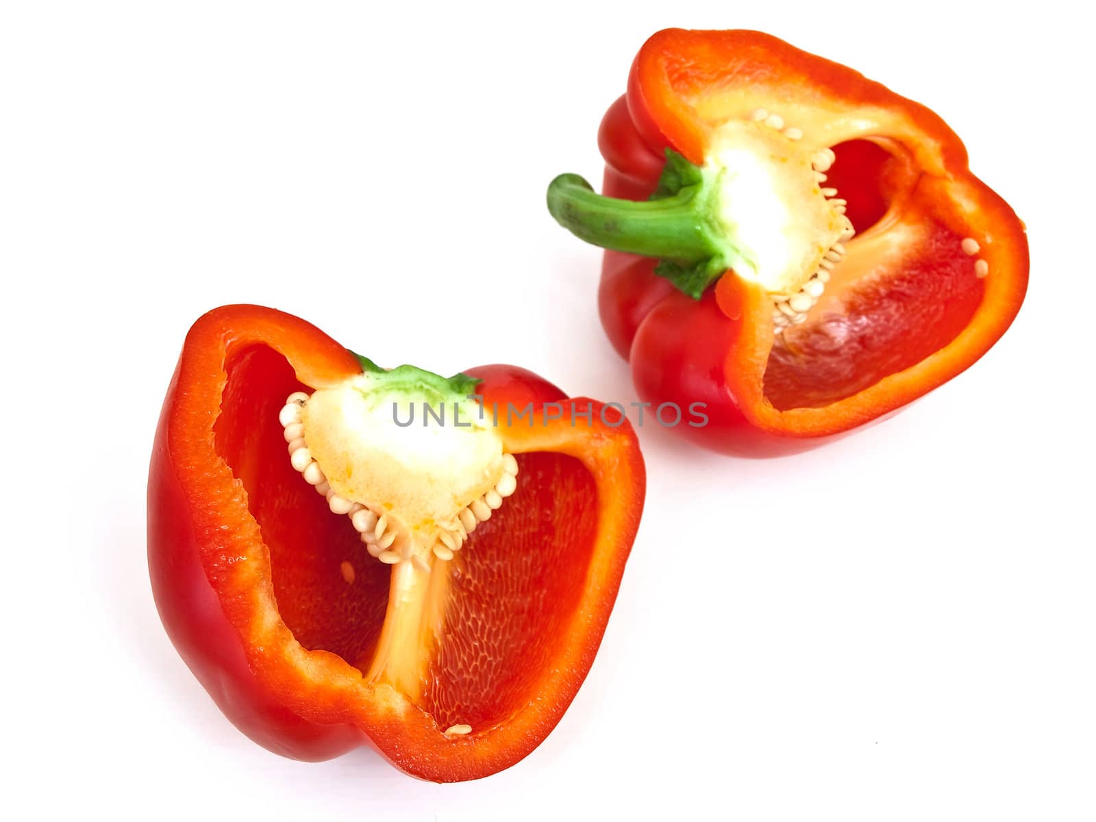 Photo of the  red paprika slices against the white background