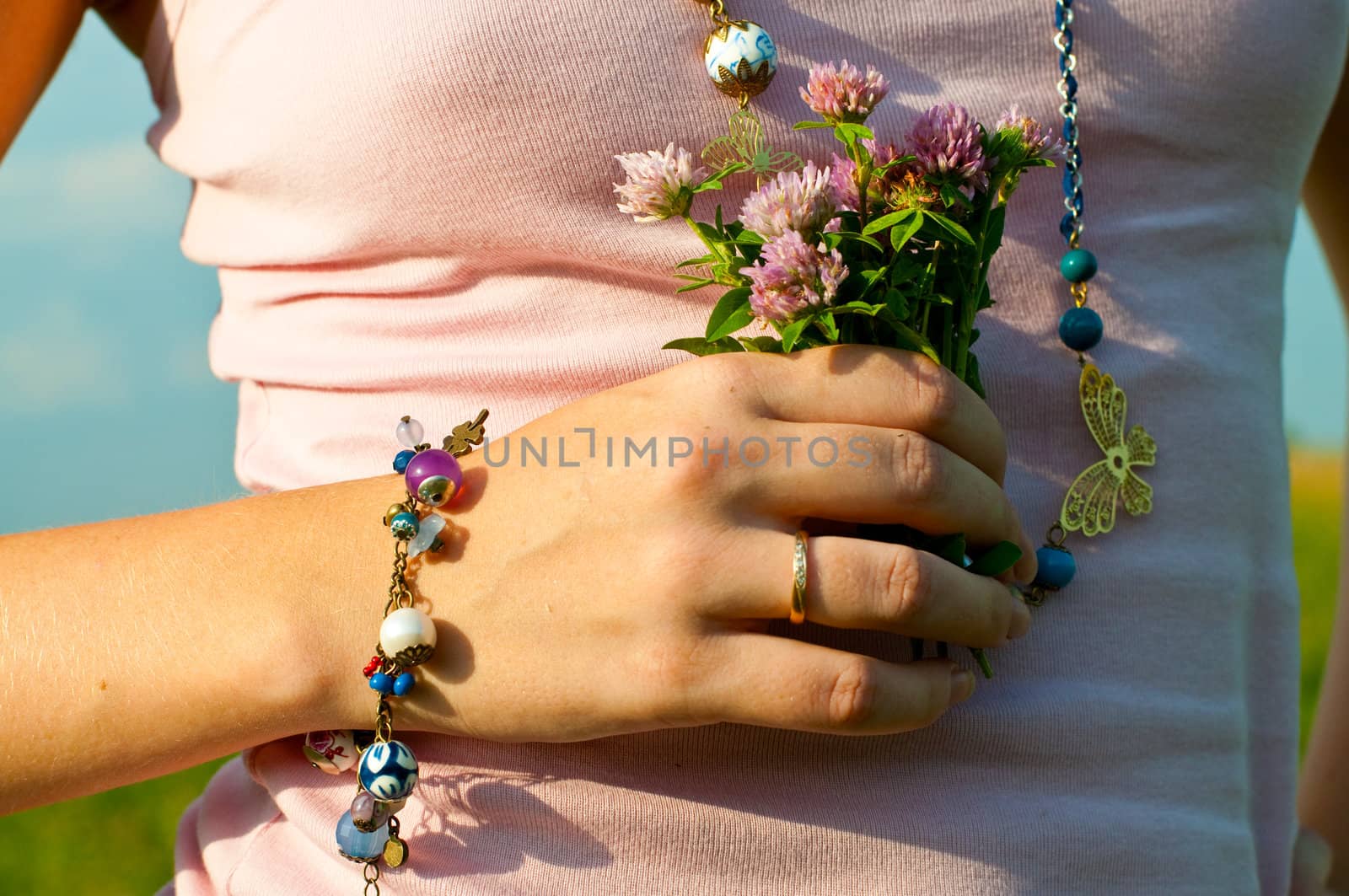 The picture of the woman's hand with bunch of flowers