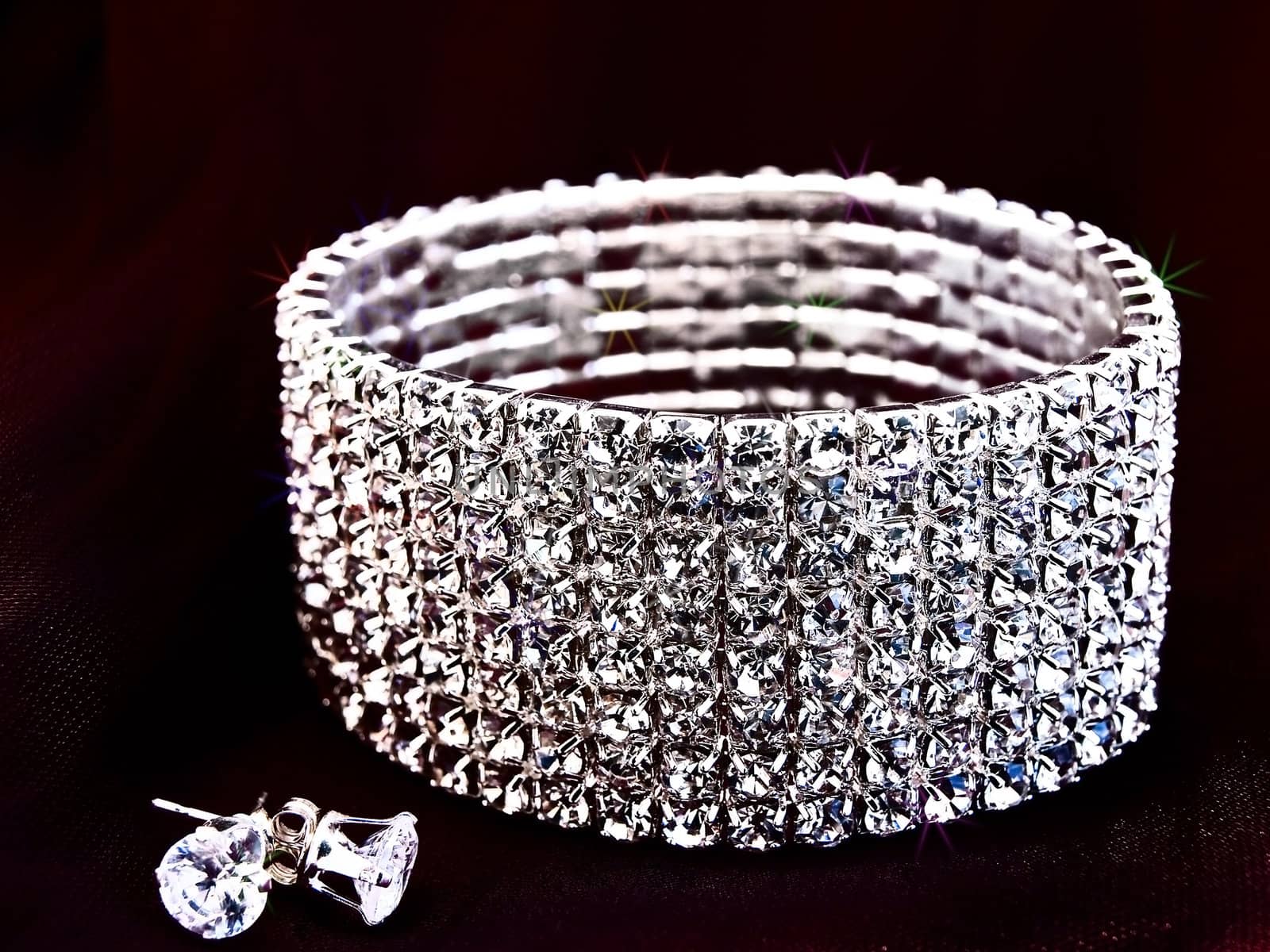 brilliant bracelet and earrings at the dark textile