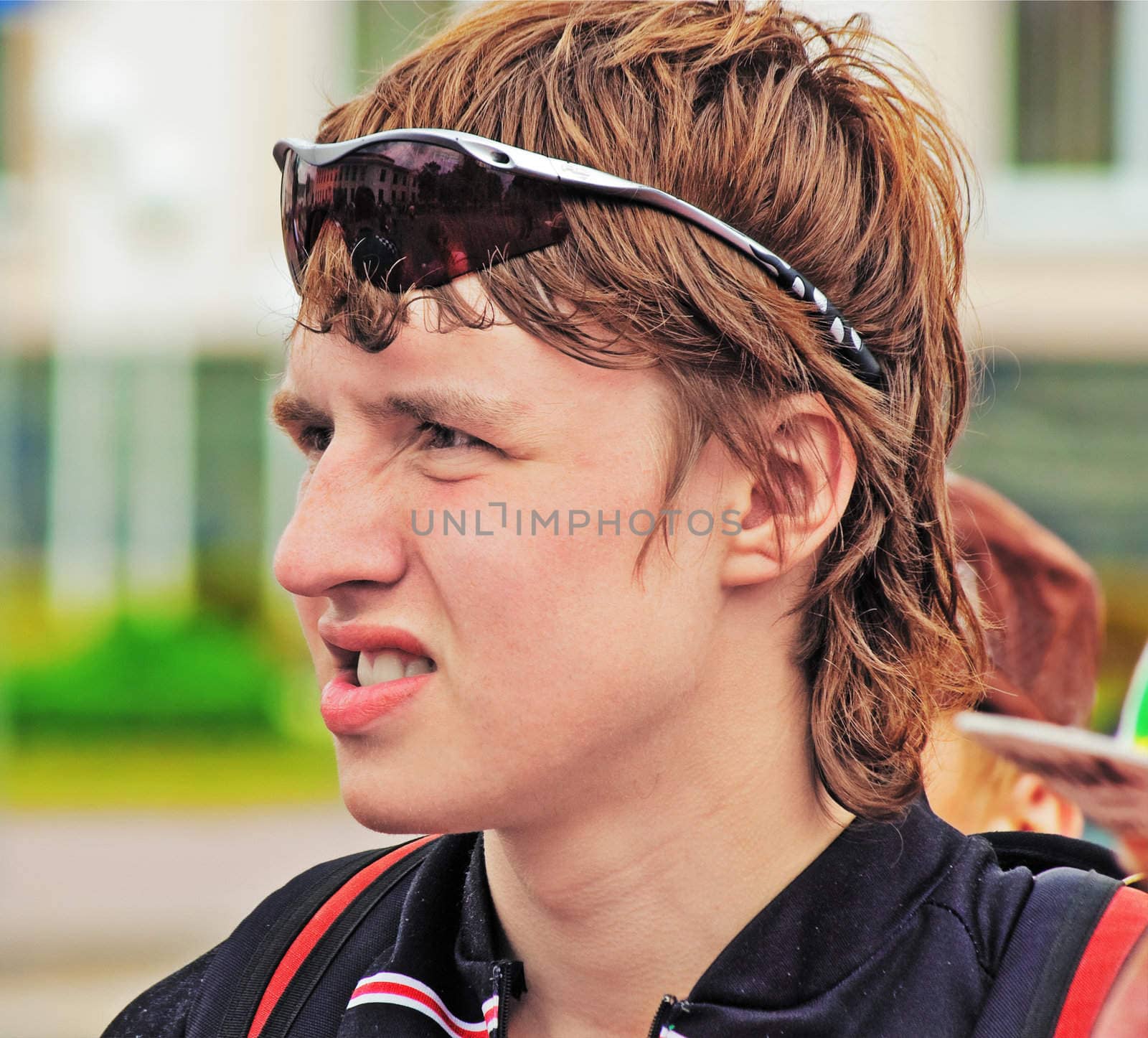 Portrait of the young sportsman in dark glasses