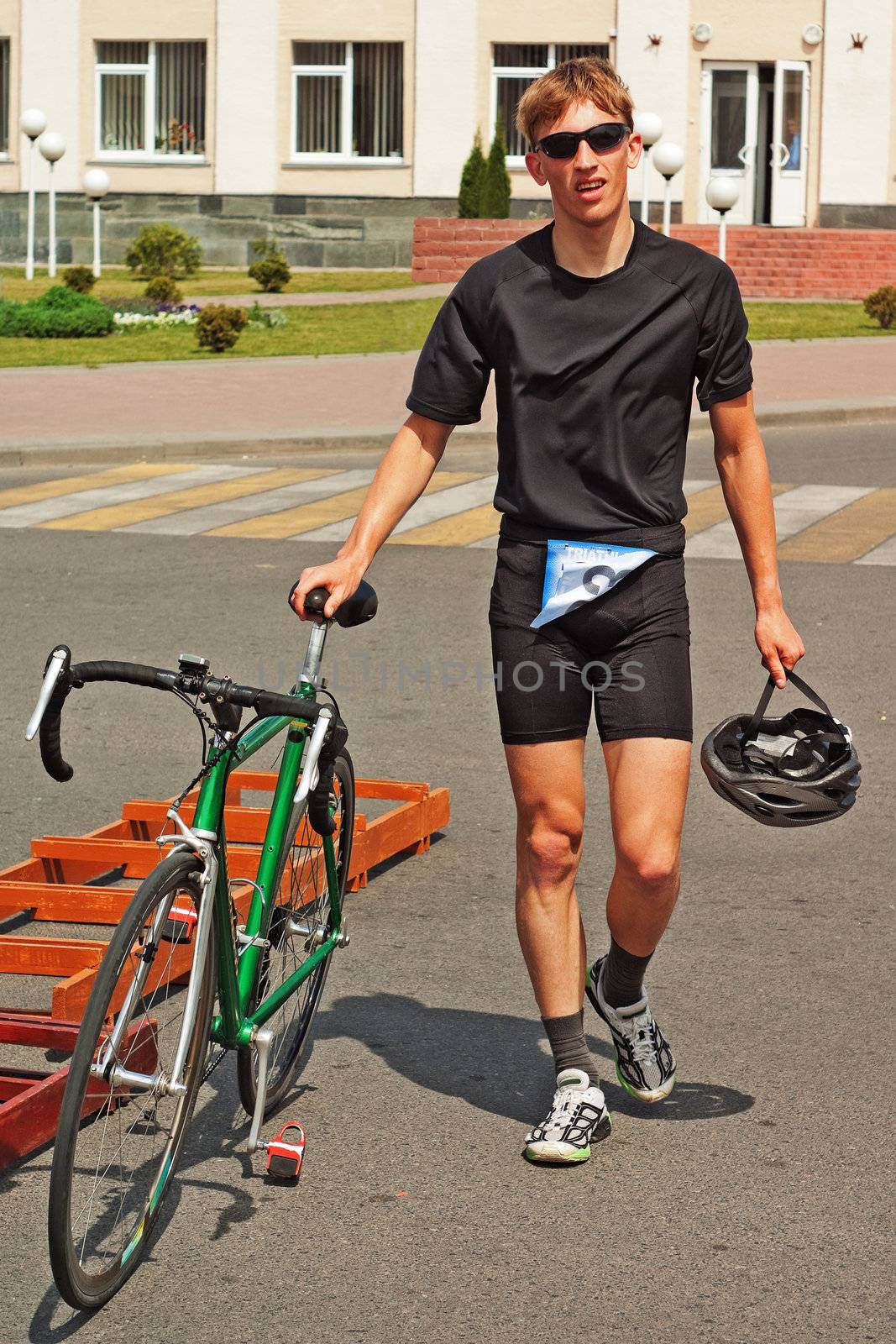 triathlon  competition participant with  green bicycle