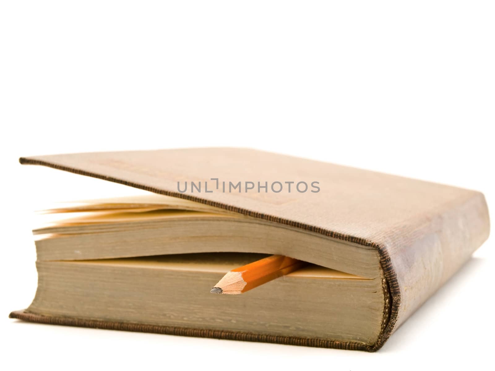 pencil and used brown book over the white background