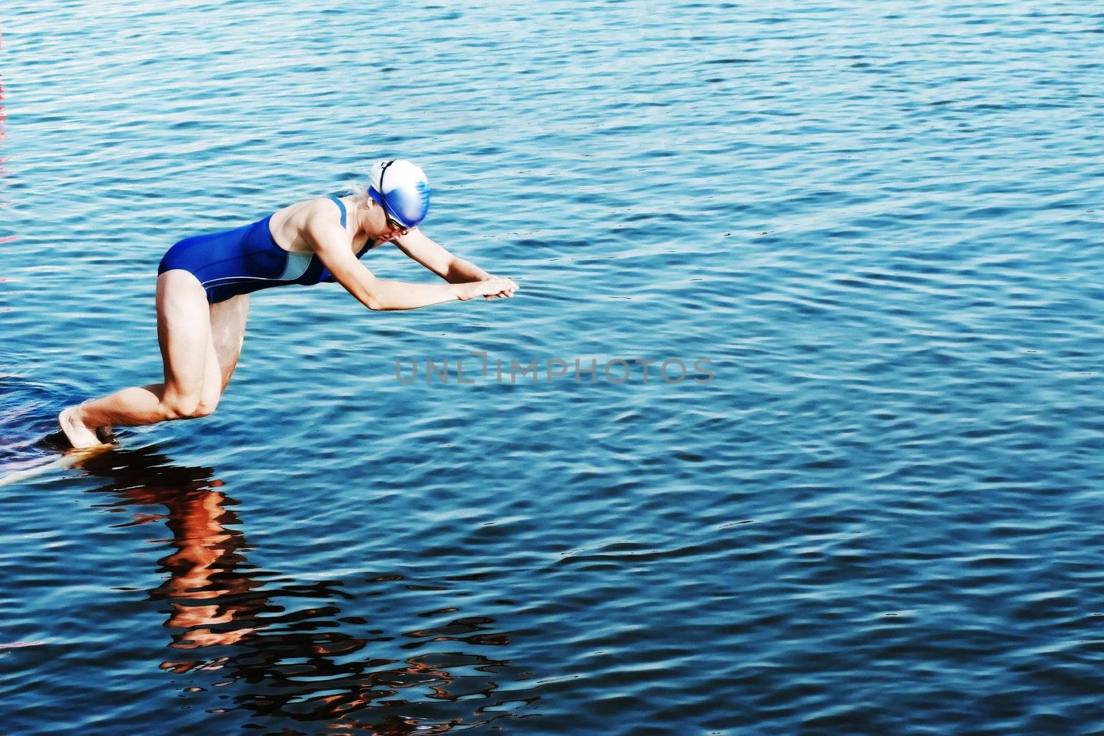 The sportswoman jumps in water at competitions