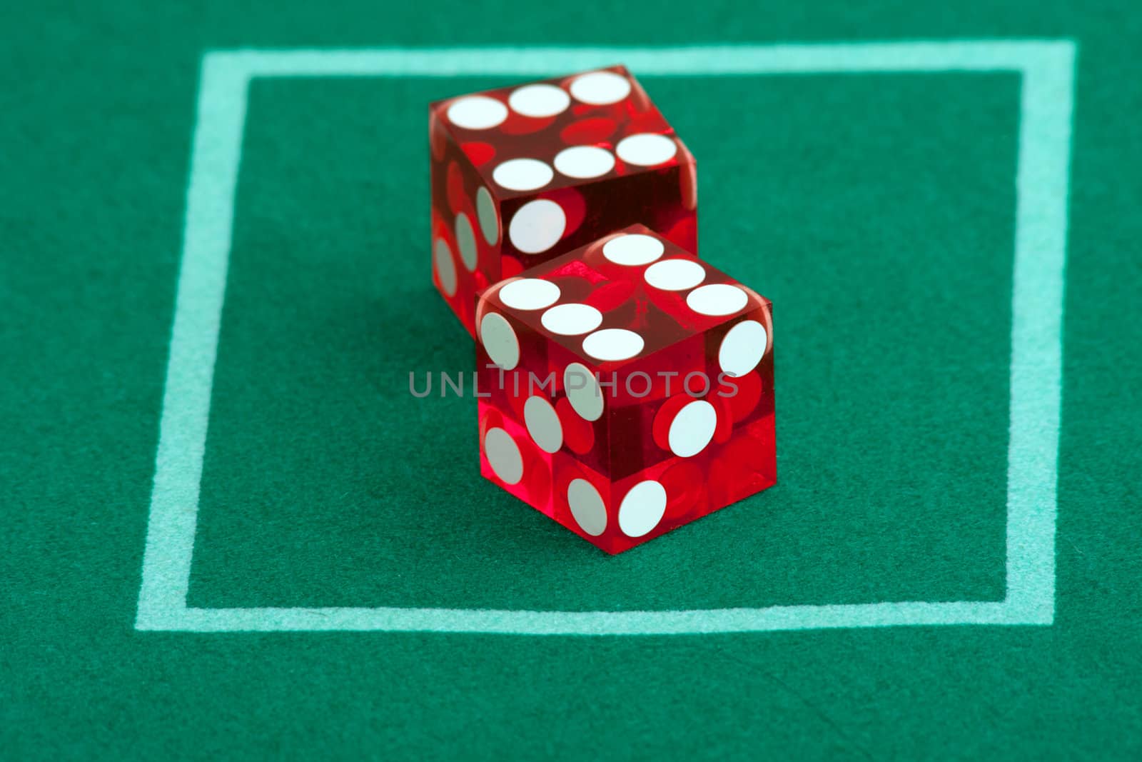 Pair of dice on green casino table felt, 12 rolled