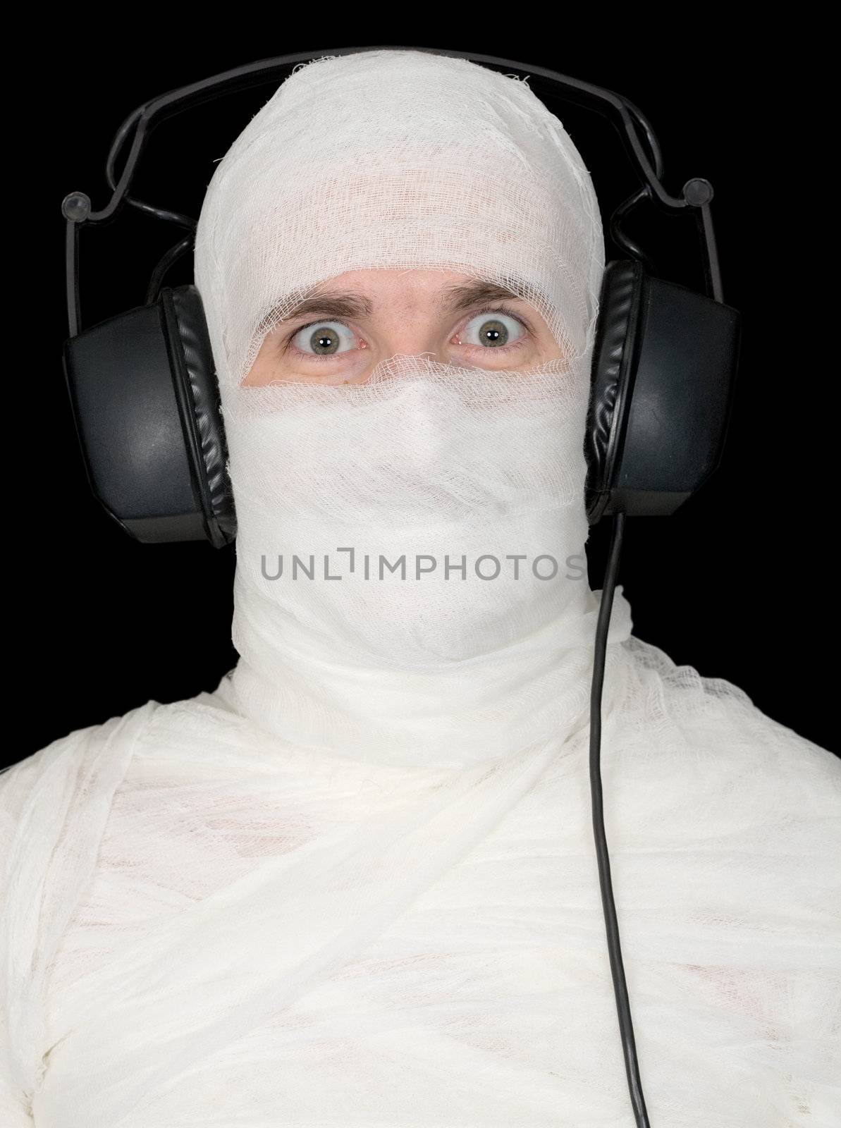 Man in bandage with ear-phones on black