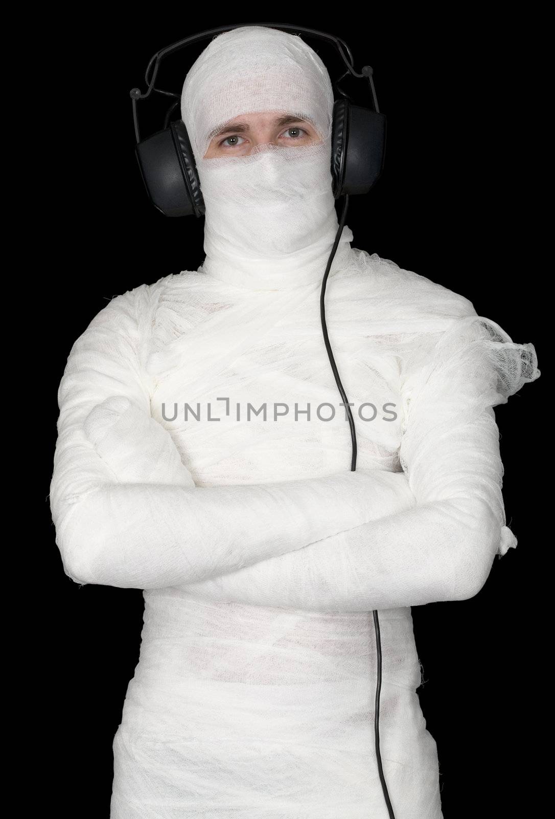 Man in bandage with ear-phones on black