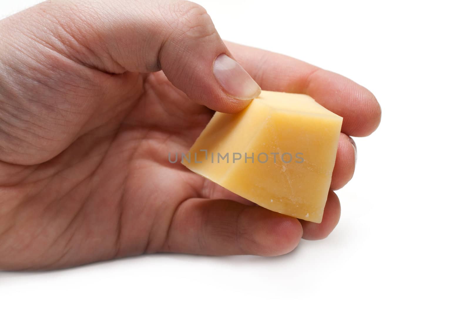 Piece of the cheese in hand on white background