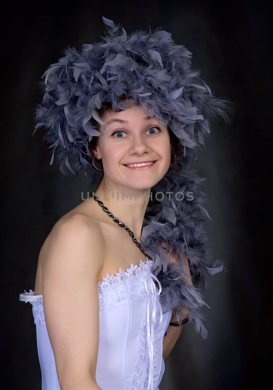 Portrait of the beautiful girl with a boa on a head