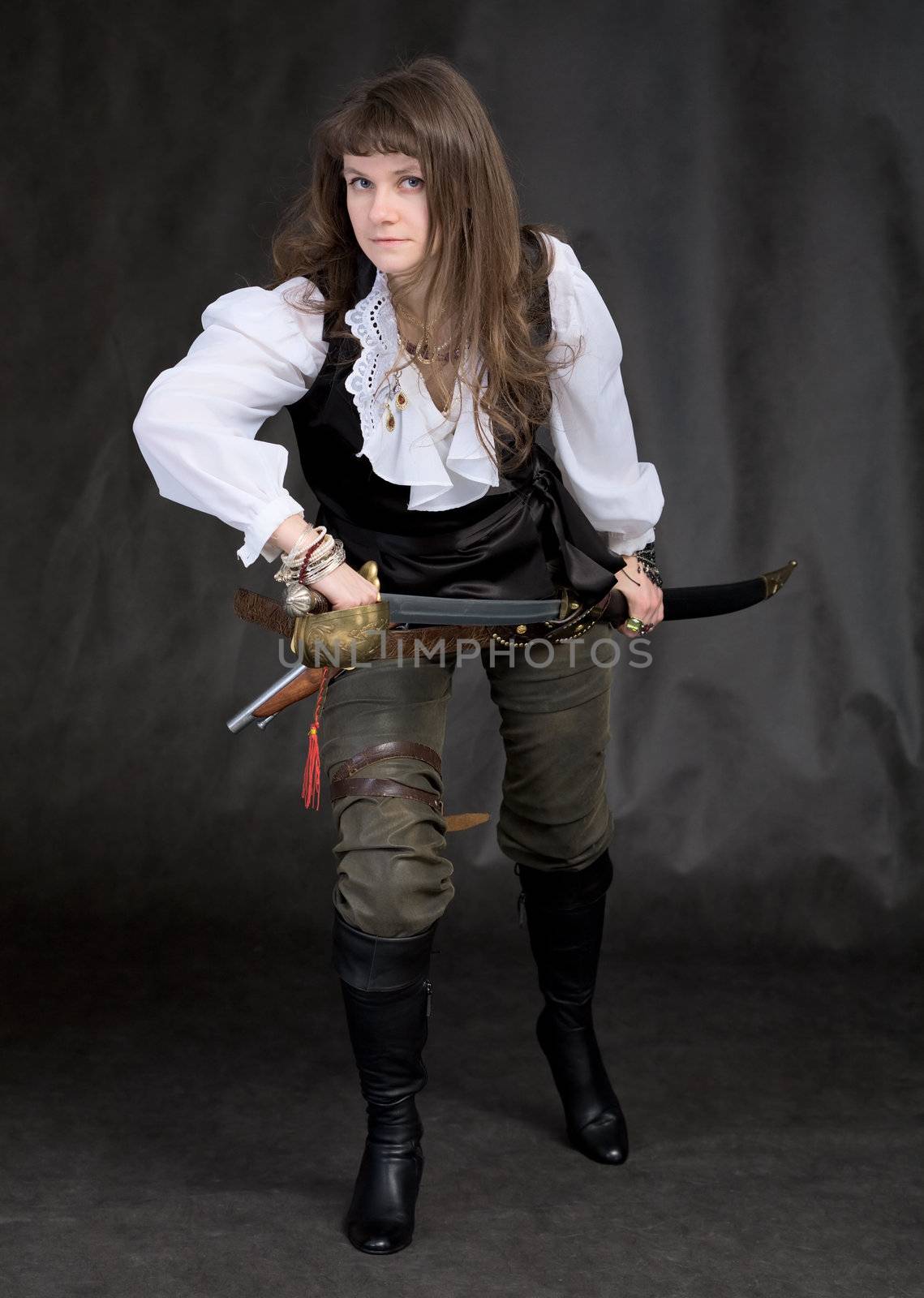 The girl - pirate with a sabre in hands on a black background