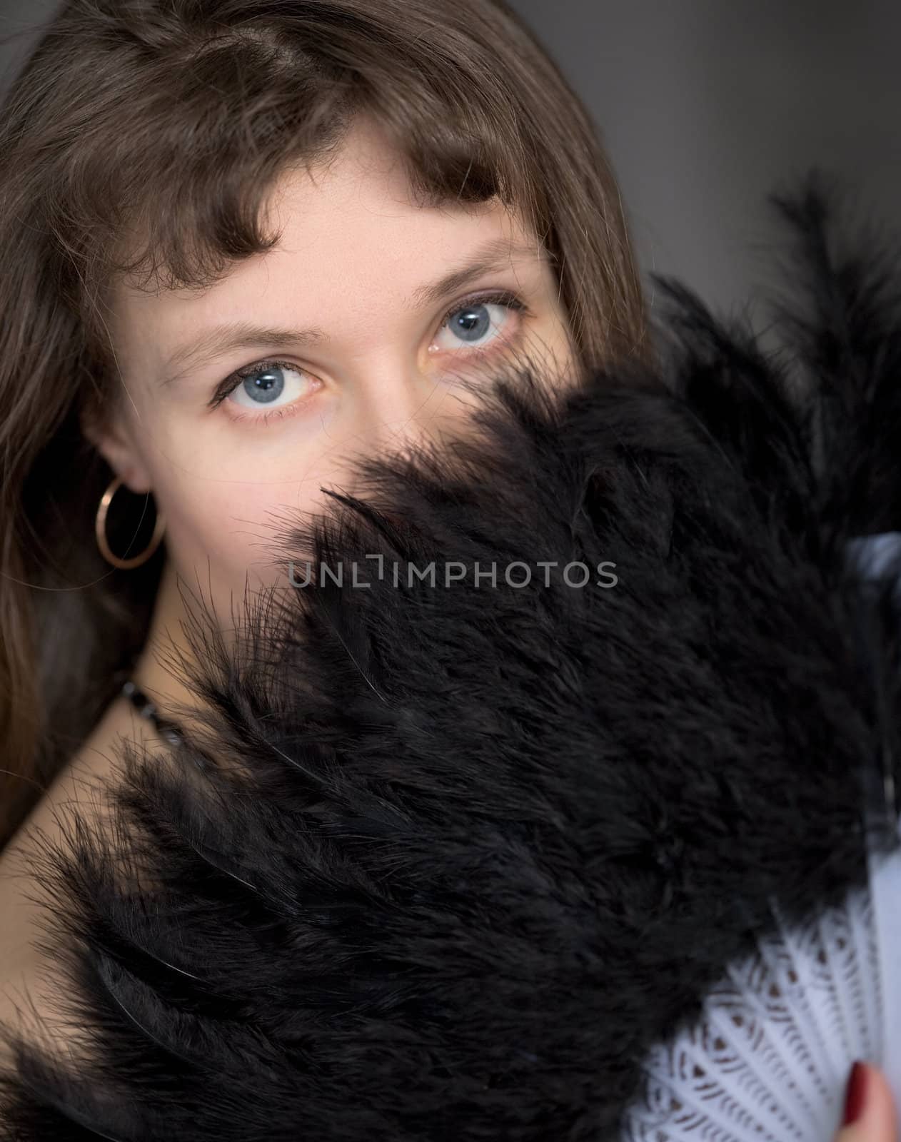 Portrait of the girl with a fan in hand