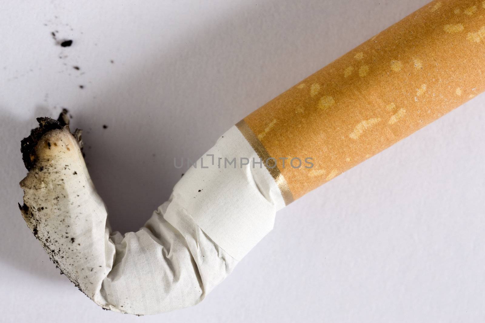 a cigarette butt on white 