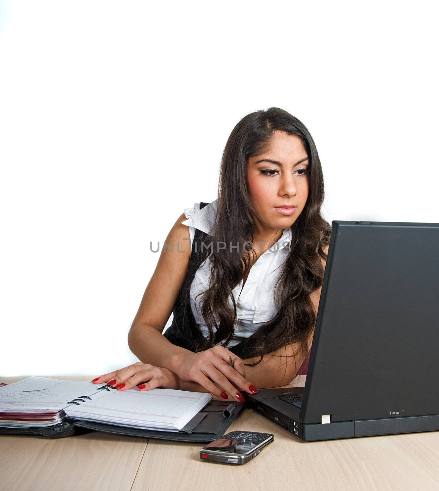 Beautiful girl working on her computer, isolated on white background