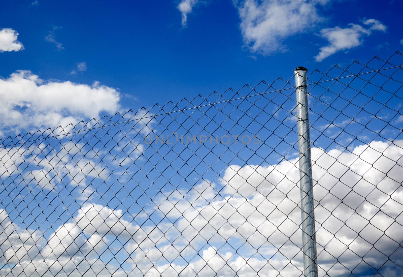 Suggestive image of metal fence against the sky