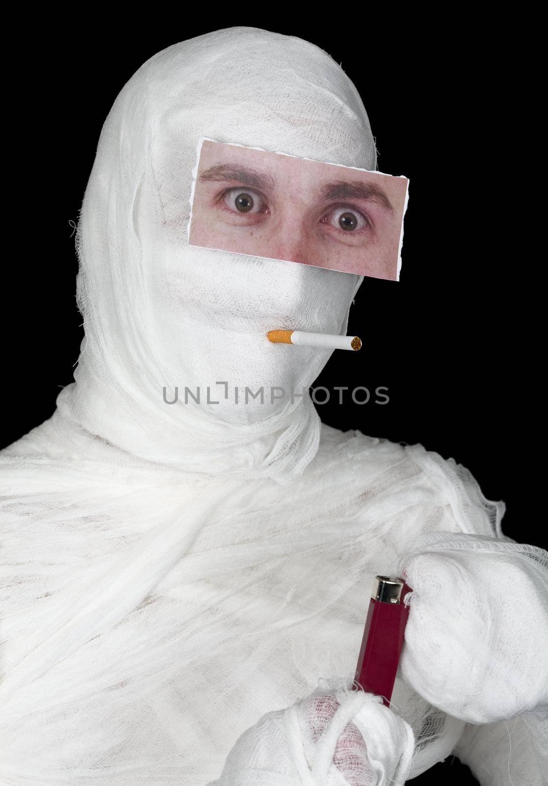 Mummy with false eye and lighter on the black background