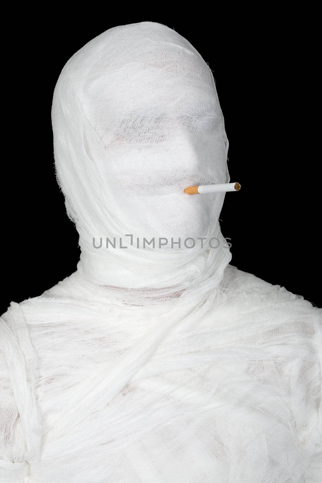 Mummy with cigarette on the black background