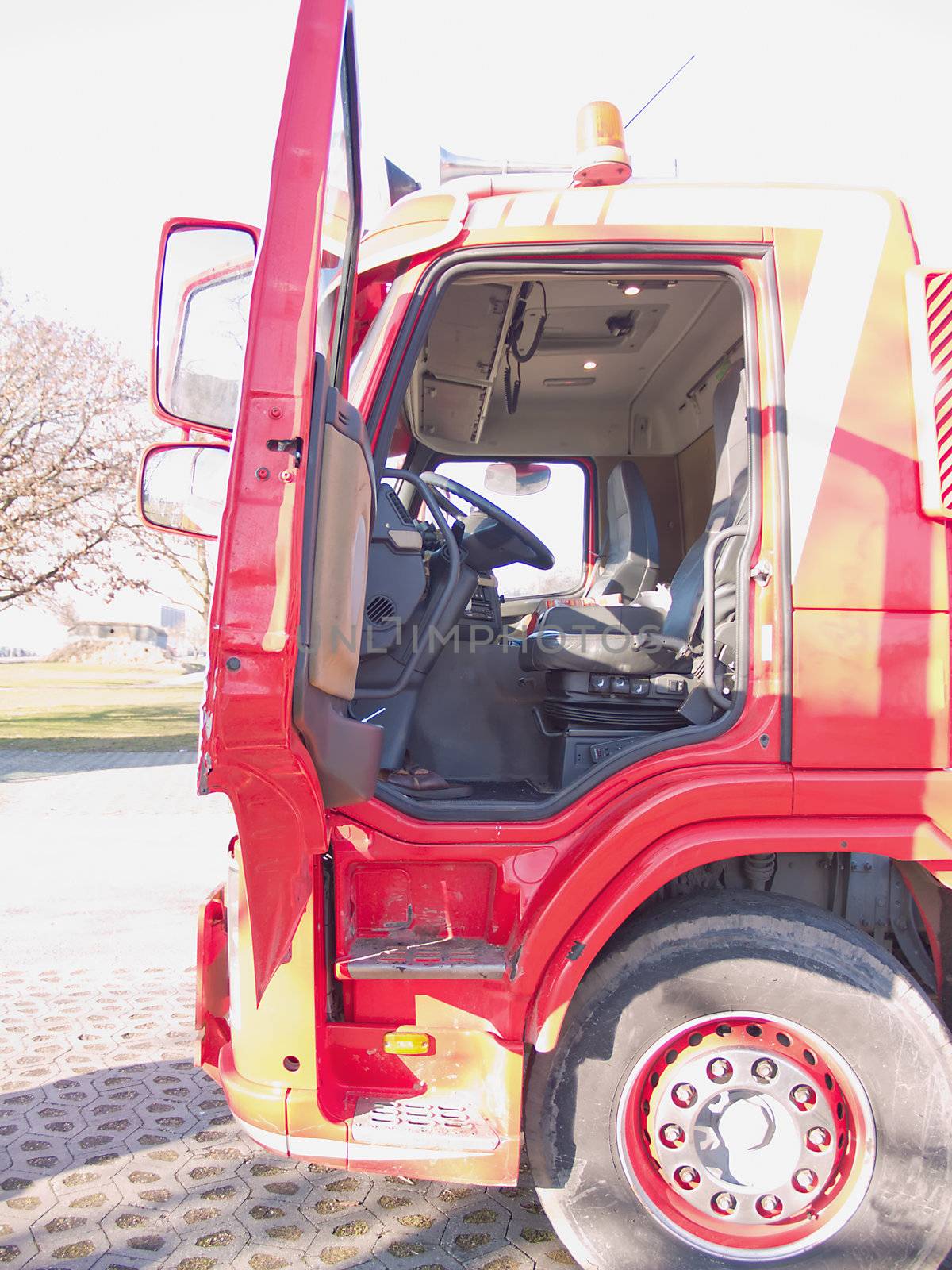 Drivers side door opening of a big  red truck