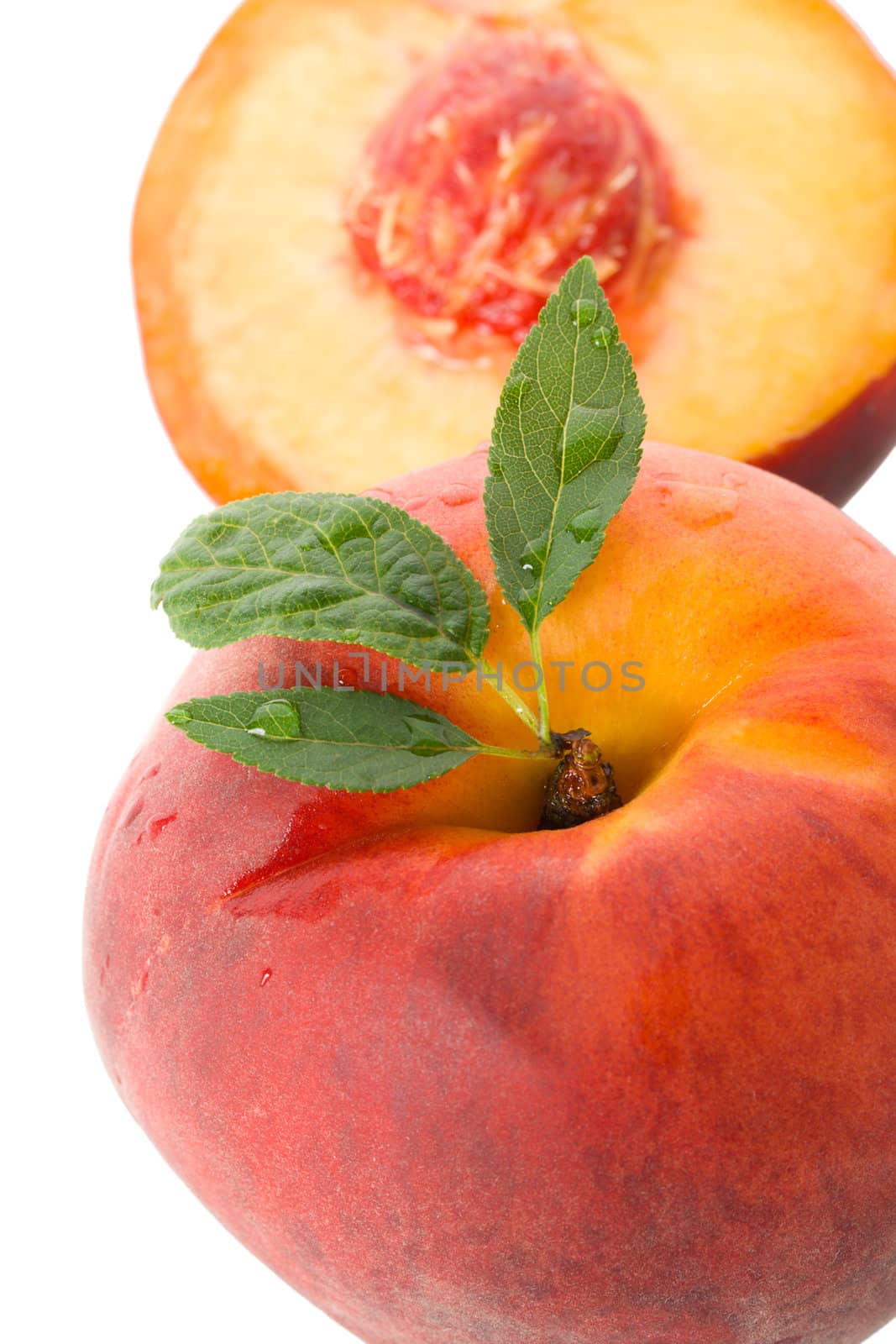 close-up ripe peach with leaves, isolated on white