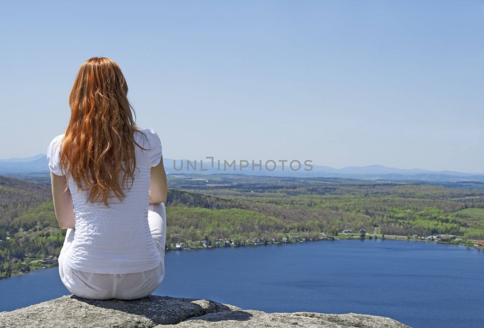 Young woman on top of a mountain by anikasalsera