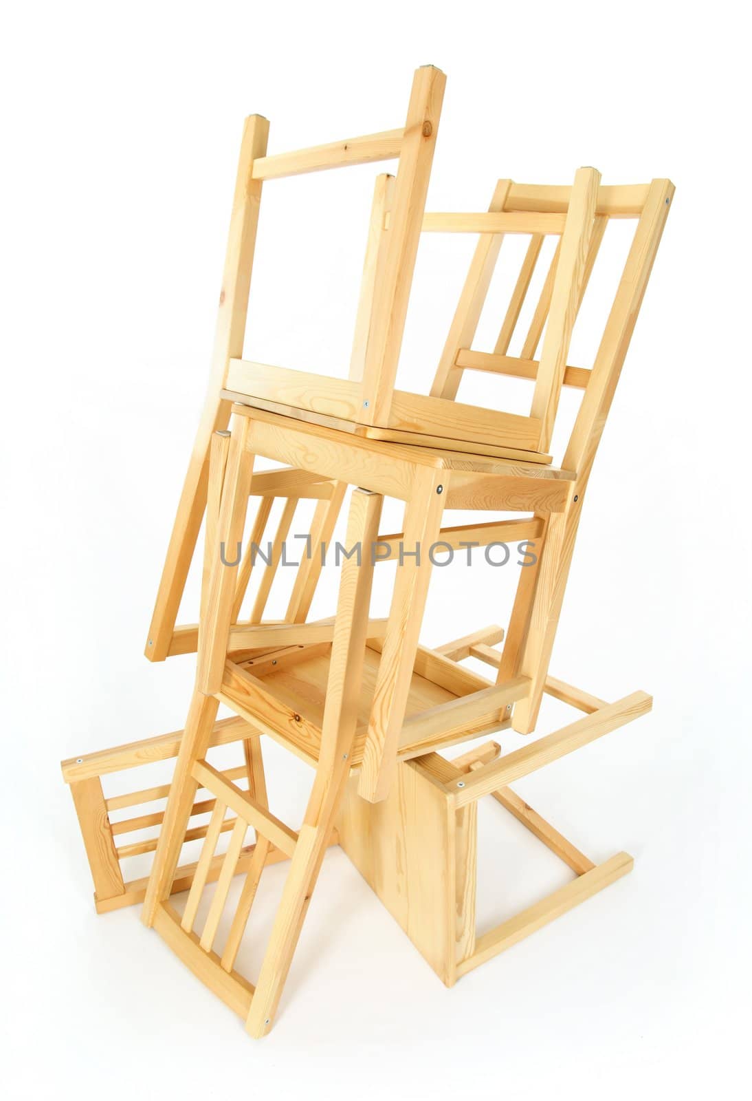 Stacked wooden chairs on white background.