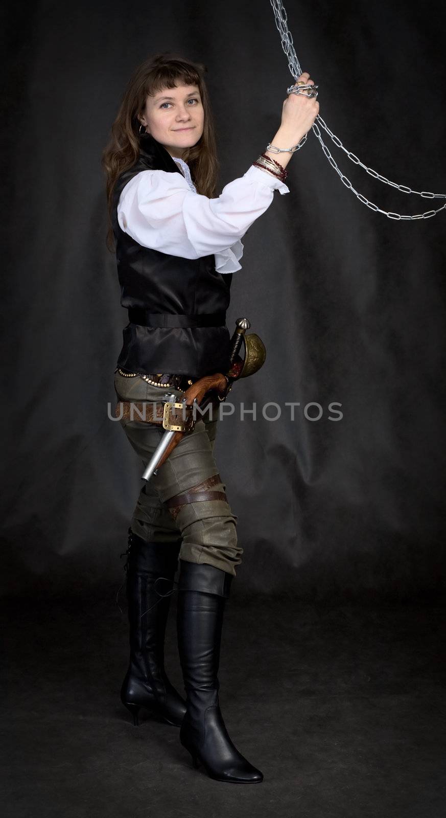 The girl - pirate with a sabre in hands on a black background