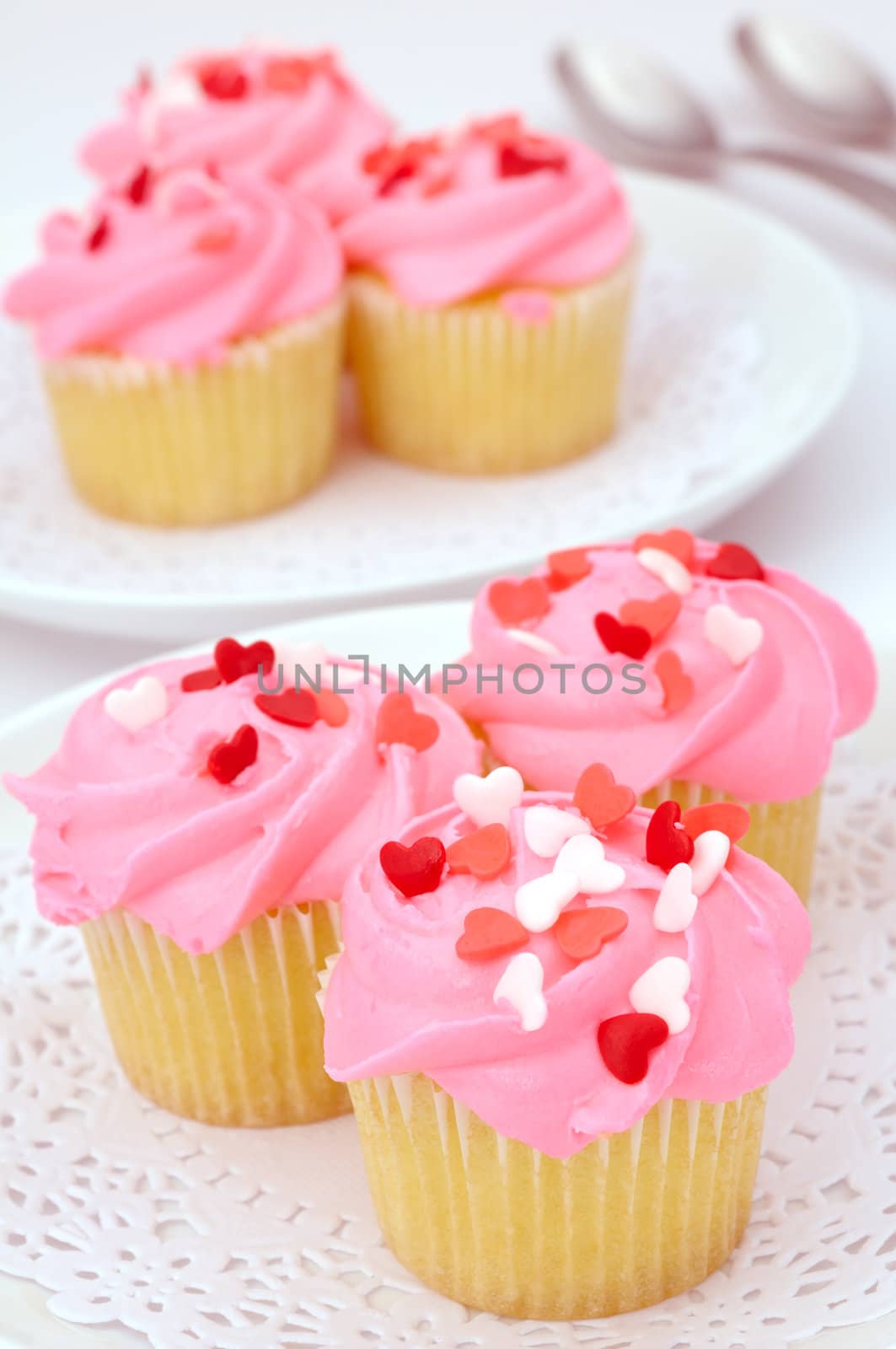 Small pink cupcakes decorated with heart candies