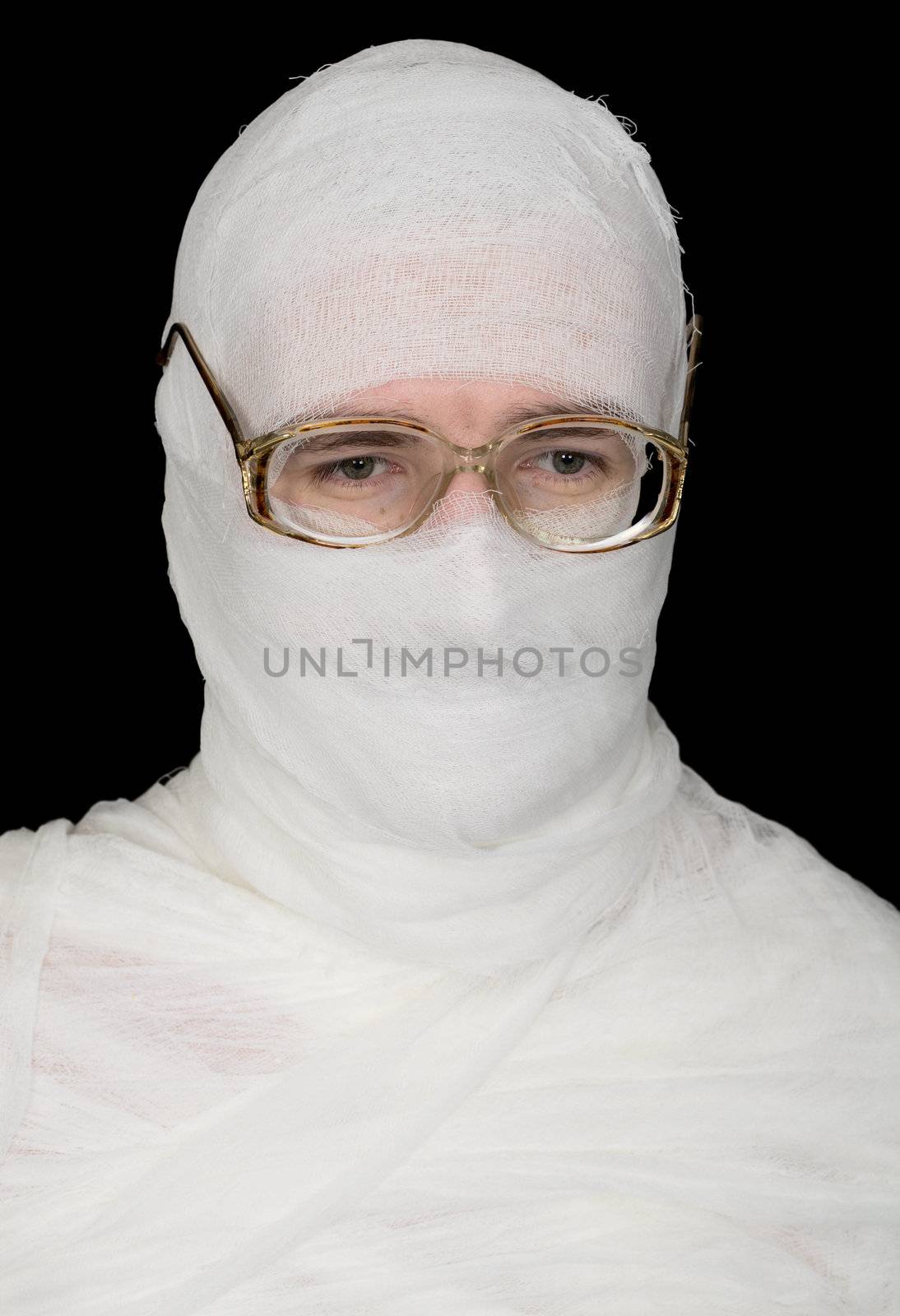 Sorrowful bandaged men in spectacles on black background