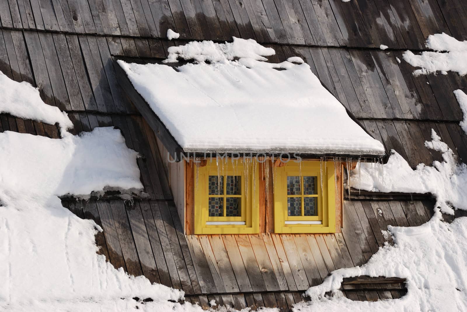 Window on old Serbian wooden house in winter.