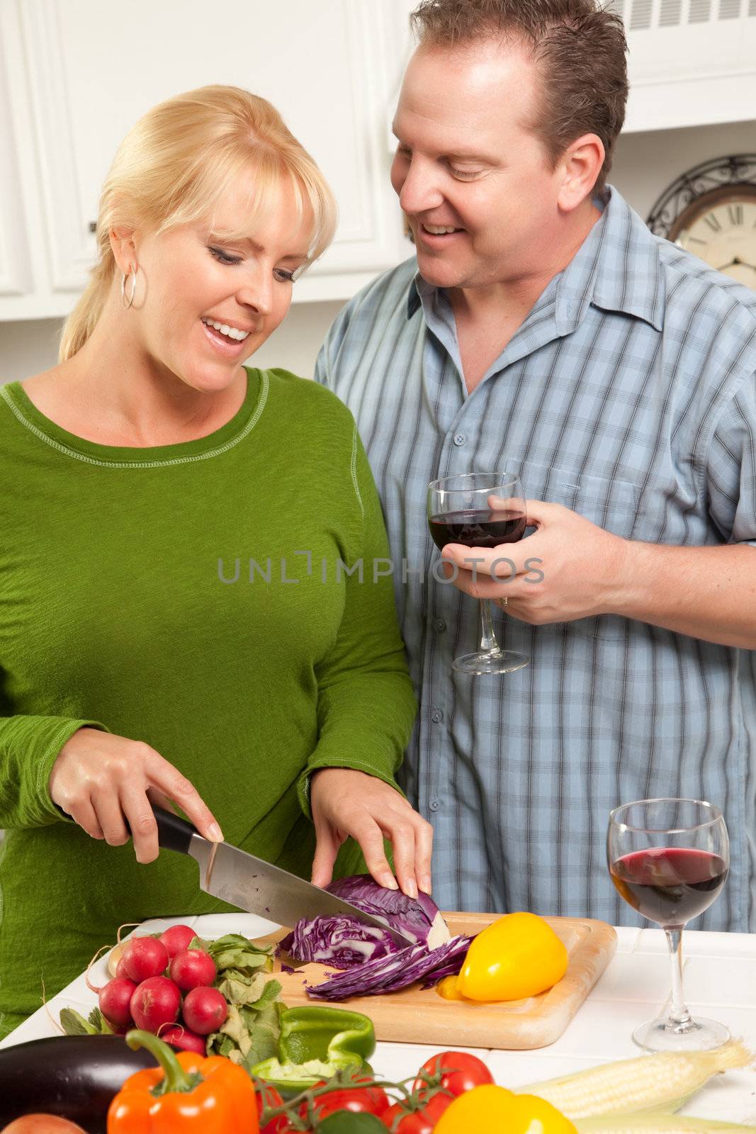 Happy Couple Enjoying An Evening Preparing Food in the Kitchen.