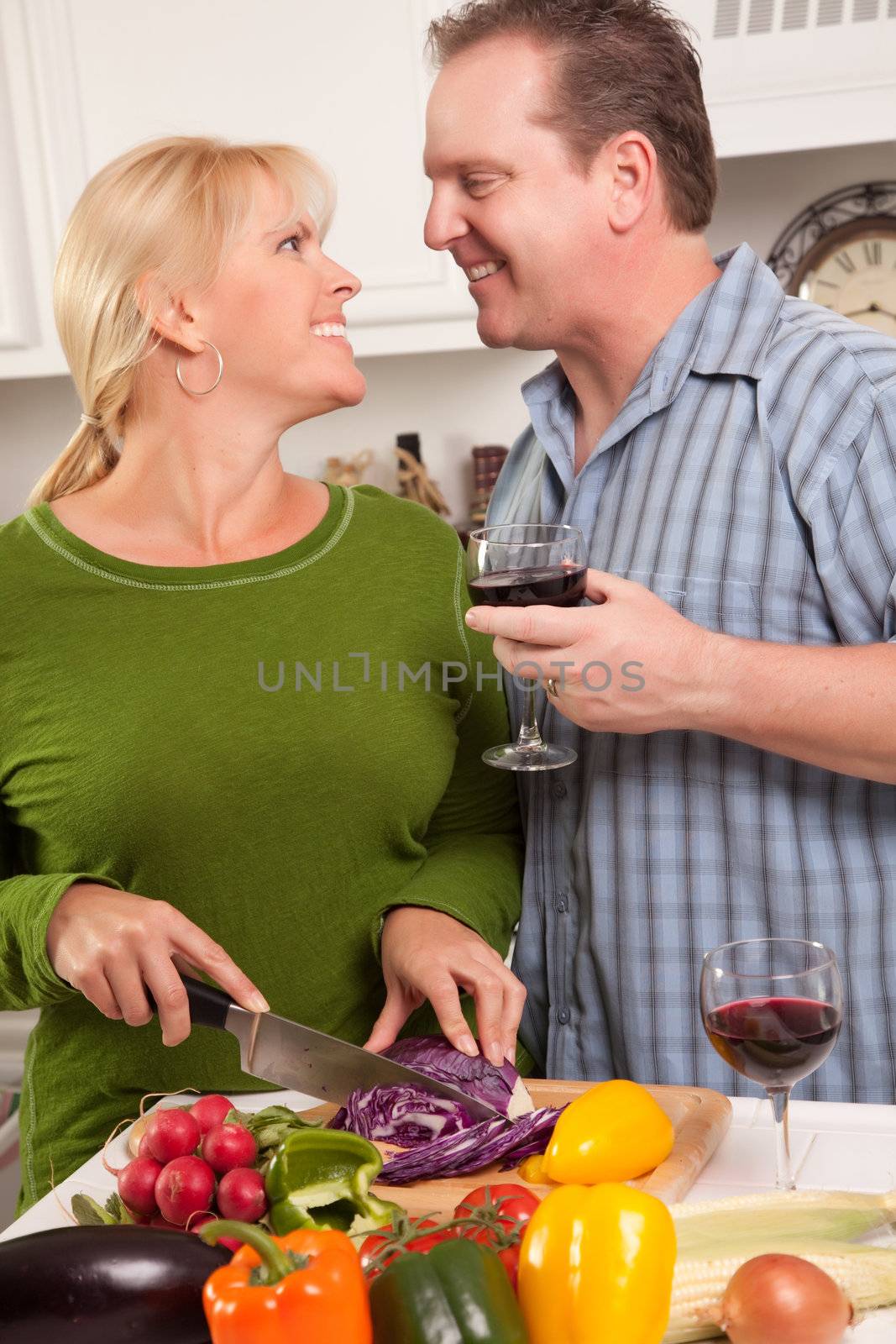 Happy Couple Enjoying An Evening Preparing Food in the Kitchen.