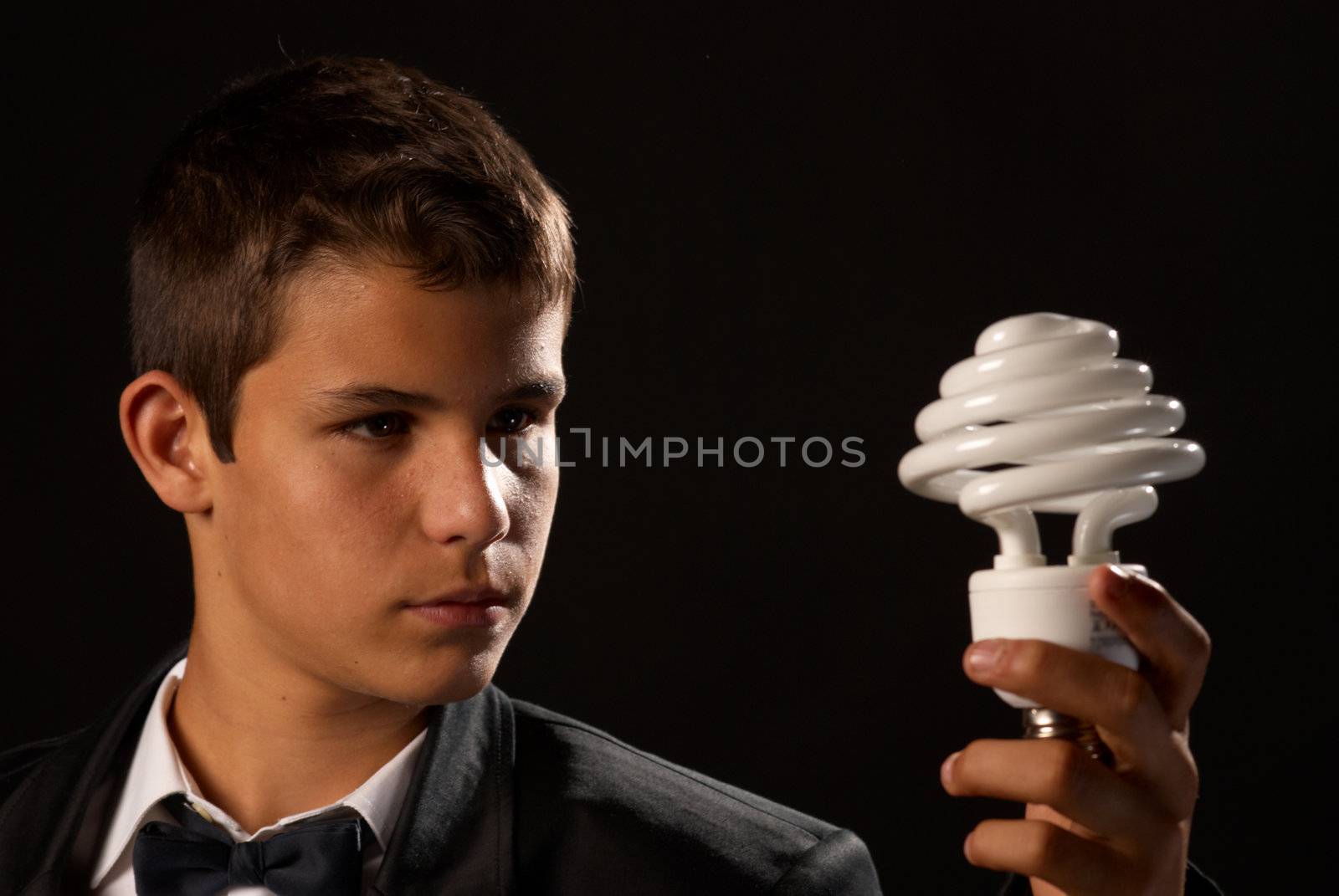 Environmental awareness, teen holding a energy saving bulb