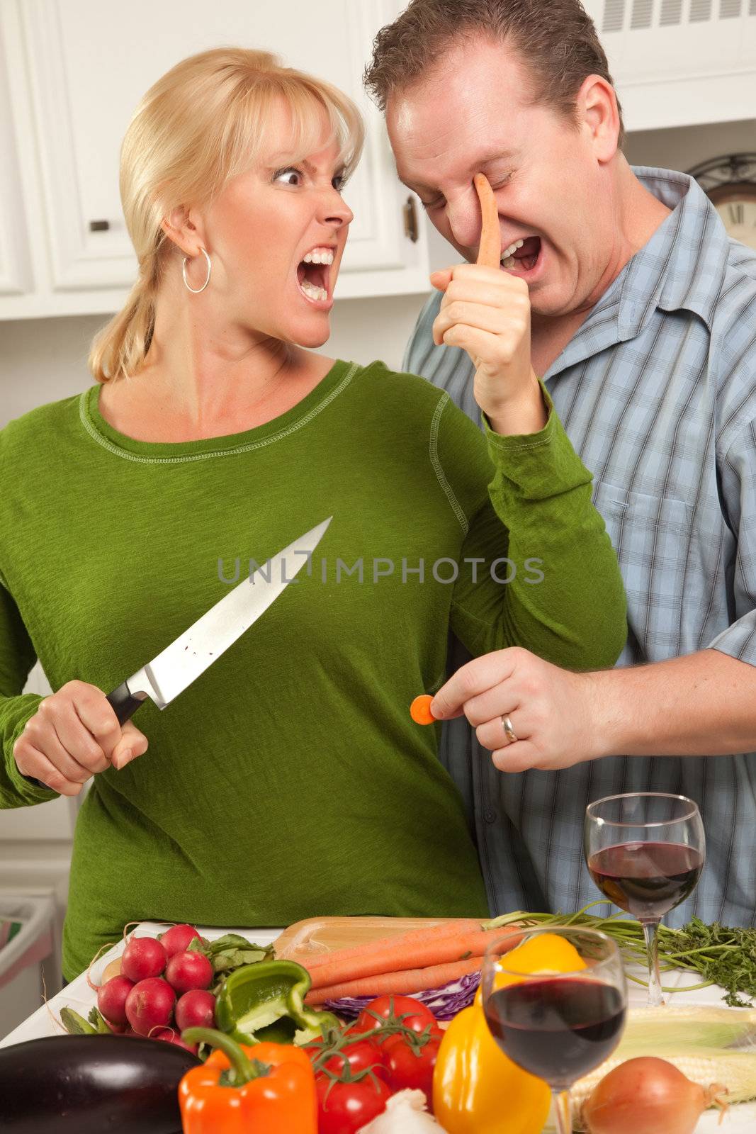 Happy Couple Enjoying An Evening Preparing Food in the Kitchen.