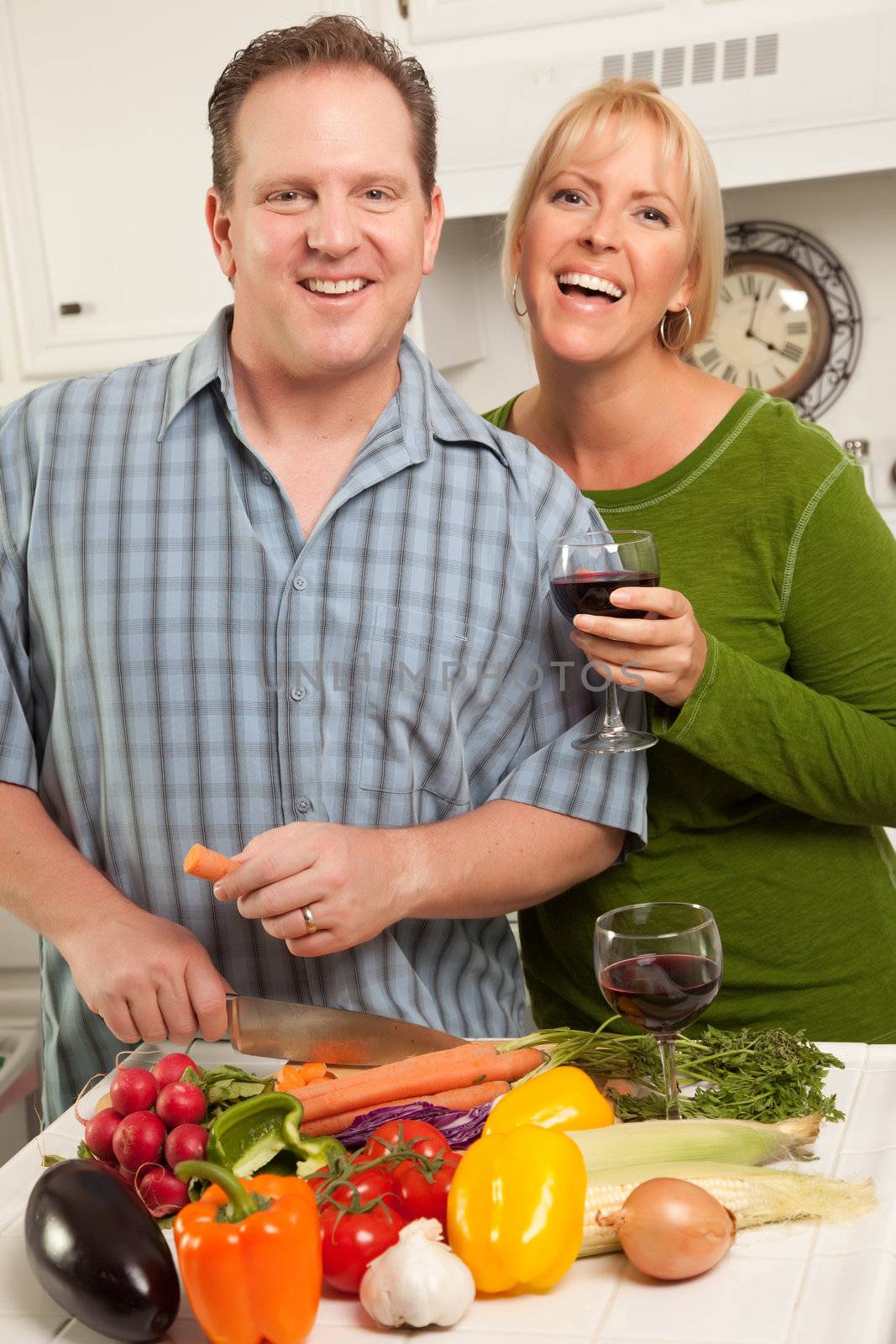 Happy Couple Enjoying An Evening Preparing Food in the Kitchen.