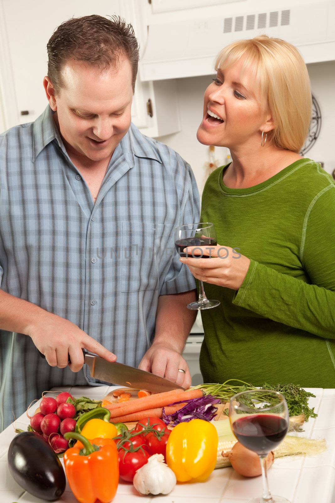 Happy Couple Enjoying An Evening Preparing Food in the Kitchen.