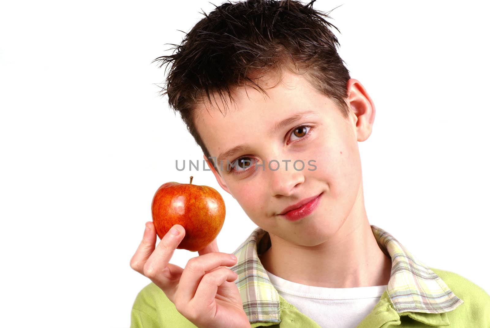 Boy holding up an apple on white.      